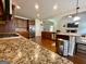 Spacious kitchen featuring granite countertops, stainless steel appliances, and dark wood cabinetry at 116 Standford Dr, Mcdonough, GA 30252