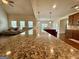 Open concept kitchen with granite countertops, island with seating, and a view to the living area at 116 Standford Dr, Mcdonough, GA 30252