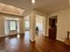Inviting living room featuring hardwood floors and an open floor plan, leading to the kitchen and dining area at 116 Standford Dr, Mcdonough, GA 30252