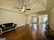 Open living room with hardwood floors and a ceiling fan, creating a comfortable space for relaxation at 116 Standford Dr, Mcdonough, GA 30252