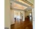 Open-concept floor plan with hardwood flooring, coffered ceilings, and views into dining and living spaces at 116 Standford Dr, Mcdonough, GA 30252