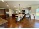 A full kitchen with island bar seating opens up to a living space with a fireplace and lots of natural light at 116 Standford Dr, Mcdonough, GA 30252