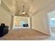 Spacious main bedroom showcasing a tray ceiling, ceiling fan, and ensuite bathroom with a soaking tub at 116 Standford Dr, Mcdonough, GA 30252