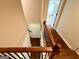 This is a staircase with hardwood treads and a white door at the top at 116 Standford Dr, Mcdonough, GA 30252
