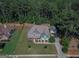 Aerial view of a two-story home with a large front lawn and mature trees at 125 Seawright Dr, Fayetteville, GA 30215