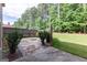Beautifully landscaped backyard featuring a stone patio with a fire pit and a privacy fence at 125 Seawright Dr, Fayetteville, GA 30215