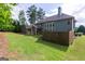 A large, grassy backyard with a fence line and the back of the house featuring many windows at 125 Seawright Dr, Fayetteville, GA 30215