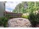 An outdoor patio with pavers in a fenced backyard surrounded by mature trees at 125 Seawright Dr, Fayetteville, GA 30215