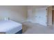 A comfortable bedroom with neutral walls, carpet flooring, and a 'Home' pillow on the bed at 125 Seawright Dr, Fayetteville, GA 30215