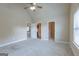 Bedroom with ceiling fan and view into bathroom and closet at 125 Seawright Dr, Fayetteville, GA 30215