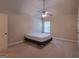 Simple bedroom with a cozy atmosphere, a ceiling fan, and natural light from a window at 125 Seawright Dr, Fayetteville, GA 30215