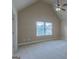 Bedroom with a ceiling fan, light carpet, and large windows at 125 Seawright Dr, Fayetteville, GA 30215