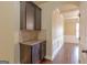 Butler's pantry with dark wood cabinets, granite countertop, and tiled backsplash at 125 Seawright Dr, Fayetteville, GA 30215