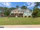 Stunning two-story home with stone accents, a inviting front porch, and a perfectly manicured lawn at 125 Seawright Dr, Fayetteville, GA 30215
