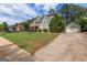 Beautiful home showcasing an exterior with lush greenery, an attached two-car garage, and a long concrete driveway at 125 Seawright Dr, Fayetteville, GA 30215