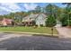 An exterior shot of a two-story home with a lush green lawn and mature landscaping on a sunny day at 125 Seawright Dr, Fayetteville, GA 30215