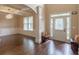 Open-concept foyer with hardwood floors, decorative columns, and seating at 125 Seawright Dr, Fayetteville, GA 30215