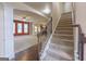 Foyer with staircase and view into the living room with red accent wall at 125 Seawright Dr, Fayetteville, GA 30215