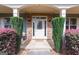The front door is framed by lush shrubs, stone accents, and a well-maintained walkway at 125 Seawright Dr, Fayetteville, GA 30215