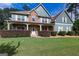 A home with a well-manicured lawn, beautiful landscaping, and a charming front porch at 125 Seawright Dr, Fayetteville, GA 30215