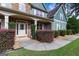 Inviting front porch with stone accents, manicured shrubs, and a welcoming entrance at 125 Seawright Dr, Fayetteville, GA 30215