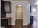 Hallway showcasing dark cabinets and hardwood floors with a view to the entryway of the house, offering an inviting space at 125 Seawright Dr, Fayetteville, GA 30215