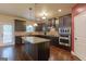 Gourmet kitchen with dark cabinetry, granite countertops, stainless steel appliances and a spacious center island at 125 Seawright Dr, Fayetteville, GA 30215