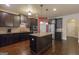 Gourmet kitchen boasts stainless appliances, granite countertops, island and dark wood cabinetry for a modern feel at 125 Seawright Dr, Fayetteville, GA 30215
