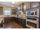 Updated kitchen with stainless steel appliances, dark wood cabinets, tile backsplash, and modern fixtures at 125 Seawright Dr, Fayetteville, GA 30215