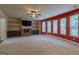 Spacious living room features a stone fireplace, ceiling fan, and built-in shelving for ample storage and display at 125 Seawright Dr, Fayetteville, GA 30215