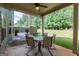 Inviting covered patio with seating, perfect for outdoor relaxation and entertaining with views of the green backyard at 125 Seawright Dr, Fayetteville, GA 30215