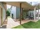 Covered patio with outdoor dining furniture, offering a perfect view of the landscaped backyard and connecting walkway at 125 Seawright Dr, Fayetteville, GA 30215