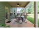 Covered patio with a ceiling fan and outdoor dining set, overlooking a lush backyard providing a relaxing outdoor space at 125 Seawright Dr, Fayetteville, GA 30215