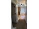 Hallway view of bathroom with a tub and tiled shower behind a tiled half wall at 90 Alcovy Reserve Way, Covington, GA 30014