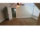 Neutral bedroom featuring plush carpet, ceiling fan, and doorway to bathroom at 90 Alcovy Reserve Way, Covington, GA 30014