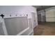 Mud room area leads into garage with bench, coat hooks, and interior door at 90 Alcovy Reserve Way, Covington, GA 30014