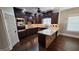 Updated kitchen with stainless steel appliances, dark wood cabinets, and granite countertops at 90 Alcovy Reserve Way, Covington, GA 30014