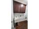 Laundry room features sleek cabinetry, basin sink, and wood flooring at 90 Alcovy Reserve Way, Covington, GA 30014
