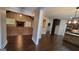 Open-concept living area with hardwood floors connecting the kitchen and Gathering room at 90 Alcovy Reserve Way, Covington, GA 30014