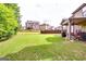 Large, green backyard featuring a covered patio area ideal for entertaining at 697 Chapman, Jonesboro, GA 30238