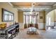 Dining room with a coffered ceiling, elegant chandelier, and a bar for entertaining at 697 Chapman, Jonesboro, GA 30238