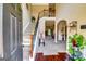Inviting foyer with hardwood floors, staircase and an open view into the main living area. Plants add a nice touch at 697 Chapman, Jonesboro, GA 30238