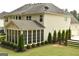 Well-manicured backyard with a screened in porch and fenced perimeter at 6660 Canyon Cv, Cumming, GA 30028