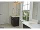 Bright bathroom featuring dual vanities, natural light, and a neutral color palette at 6660 Canyon Cv, Cumming, GA 30028