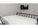 Simple bedroom features a metal bed frame, neutral bedding, and minimalist decor at 6660 Canyon Cv, Cumming, GA 30028