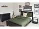 Comfortable bedroom with stylish decor, including a dresser, nightstands, and framed artwork at 6660 Canyon Cv, Cumming, GA 30028