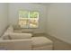 Cozy bonus room with neutral carpet and a large sectional sofa at 6660 Canyon Cv, Cumming, GA 30028