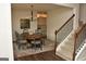 Open dining room showcasing a wood table, decorative rug, staircase, and modern light fixture at 6660 Canyon Cv, Cumming, GA 30028