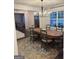 Dining room with a large wooden table and seating for six under modern lighting at 6660 Canyon Cv, Cumming, GA 30028