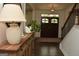 Welcoming entryway showcasing hardwood floors, a console table, and a staircase at 6660 Canyon Cv, Cumming, GA 30028